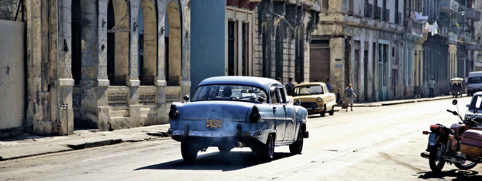 Old car driving through streets of Havana, Cuba